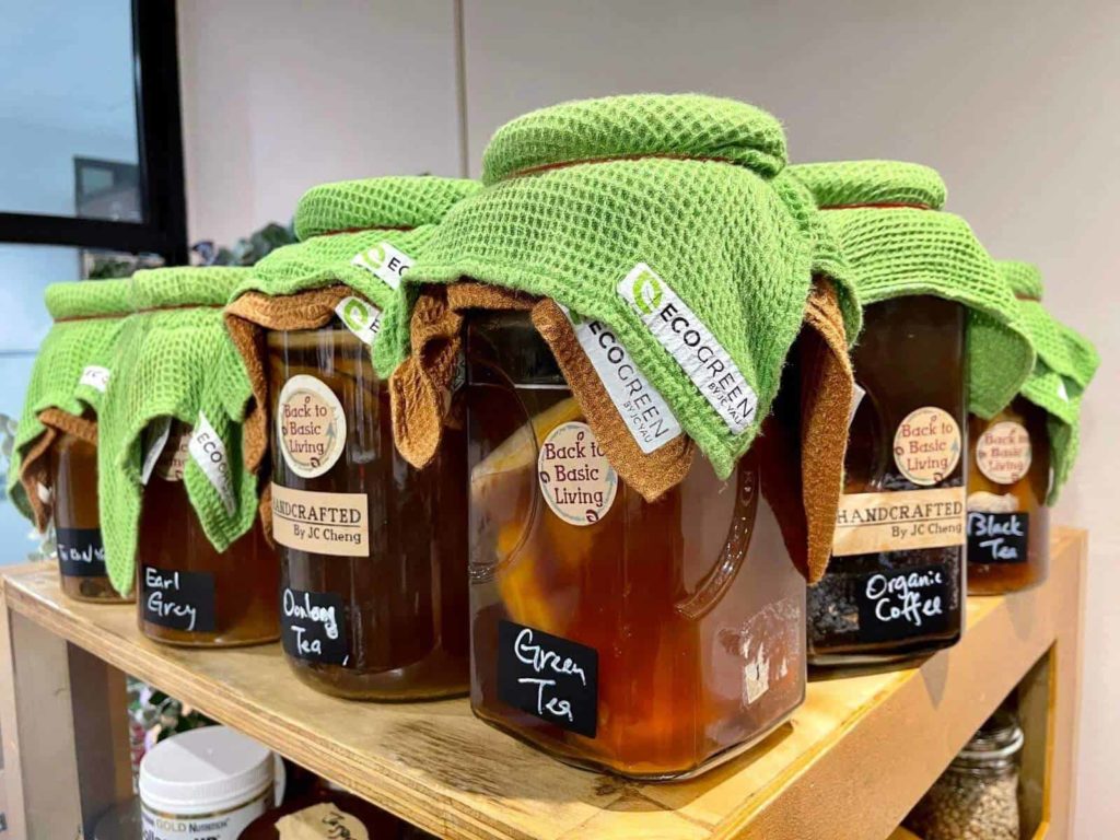 Glass jars of fermented drinks with cloth lids
