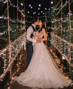 A newly-wedded couple kissing