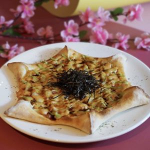 A star pizza with cheese toppings, garnish, and seaweed