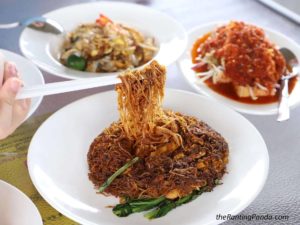 Asian dishes with red sauce and vegetables on white plates