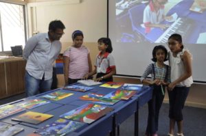 Students and a teacher during an art exhibit