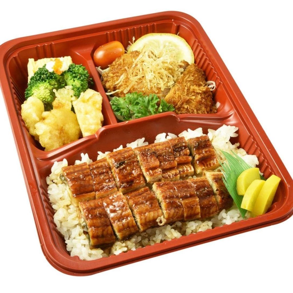 A Japanese bento with grilled meat, fish, and vegetables