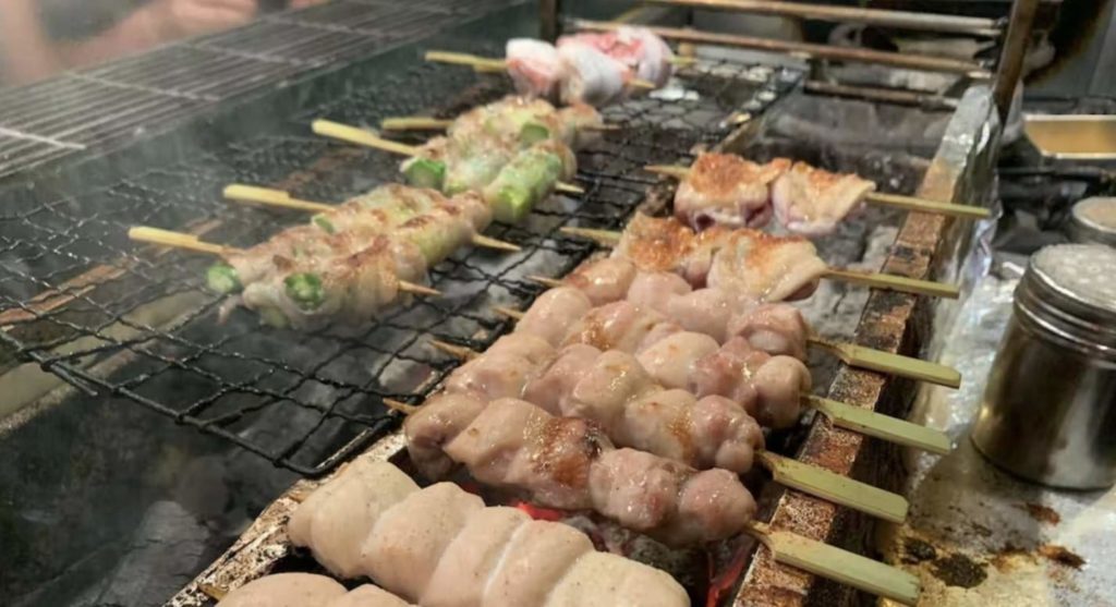Assorted Japanese grilled meat on a grill